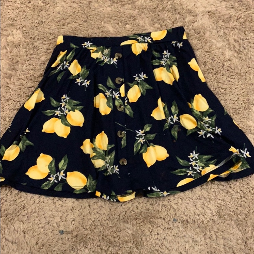 A navy blue flowy skirt with lemon print